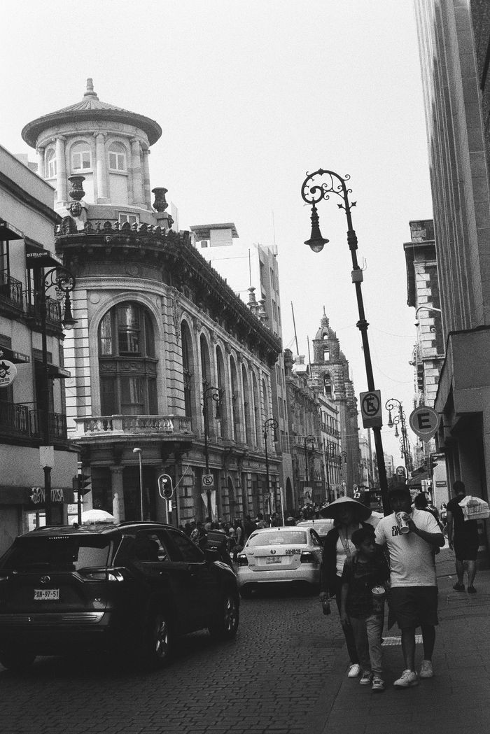 Elegant historic street view in Mexico City, showcasing architecture and urban life.